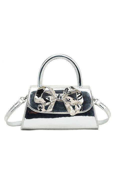Metallic Bow Top Handle Bag In Silver by SVNX