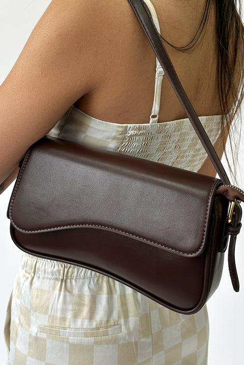 Curved Baguette Bag In Dark Brown by SVNX
