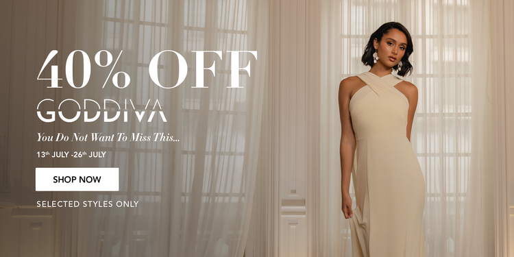 Woman in a beige dress standing in front of curtains with promotional text for Goddiva.
