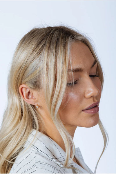 Gold - Oval Crystal Huggie Hoops by SVNX