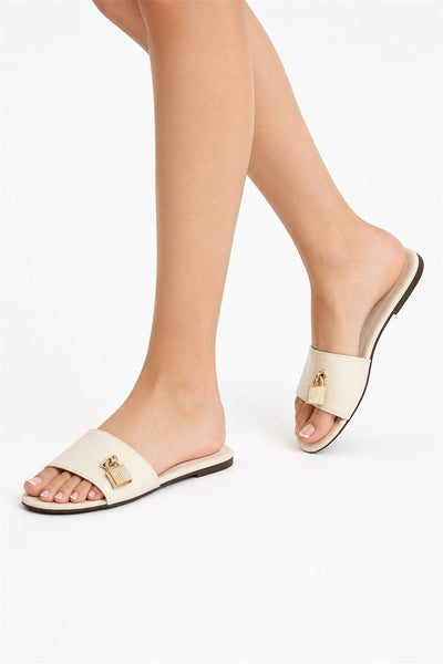 Cream - Marilyn Gold Lock Detail Band Flat Sliders In Cream by Miss Diva