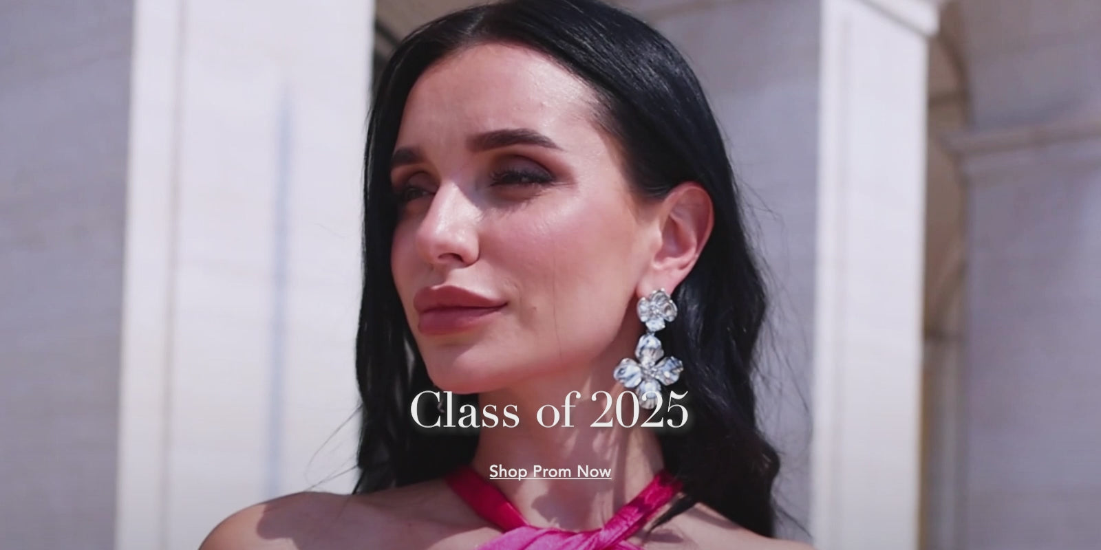 Class of 2025 prom look – a young woman stunning in a hot pink halter neck satin maxi dress, exuding elegance and confidence. 